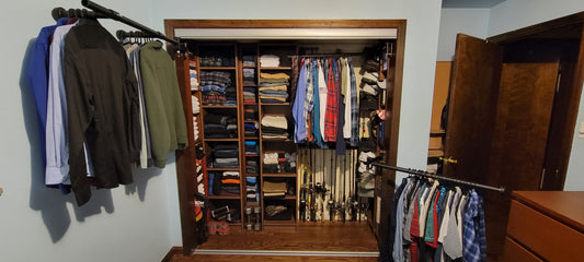 Closet rods that are expanding out of the closet standard closet rods and multiple levels with small space for fishing poles and shoes and perpendicular closet rods rotated out showing ample shelving !